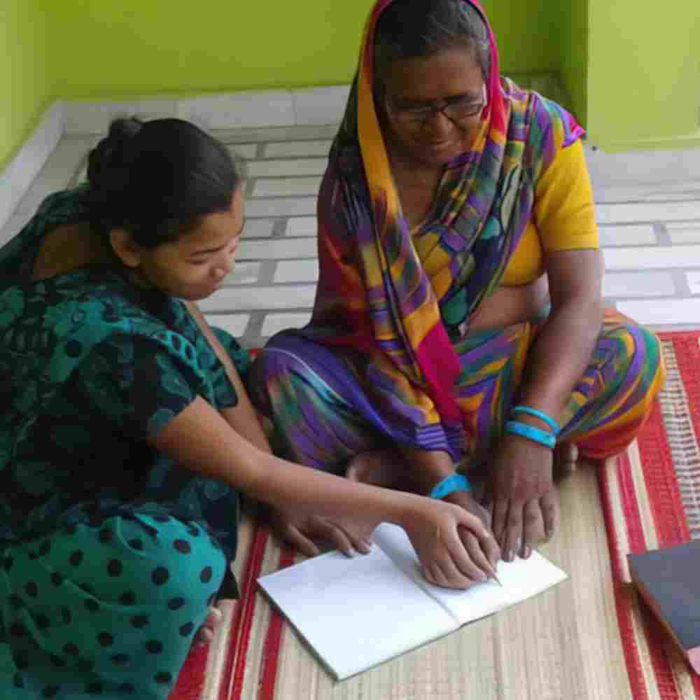 GFA World (Gospel for Asia) women missionaries gently guided Jeni as they taught her to read and write.