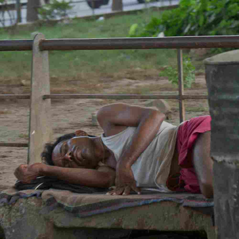 Man sleeping in the slum streets due to poverty
