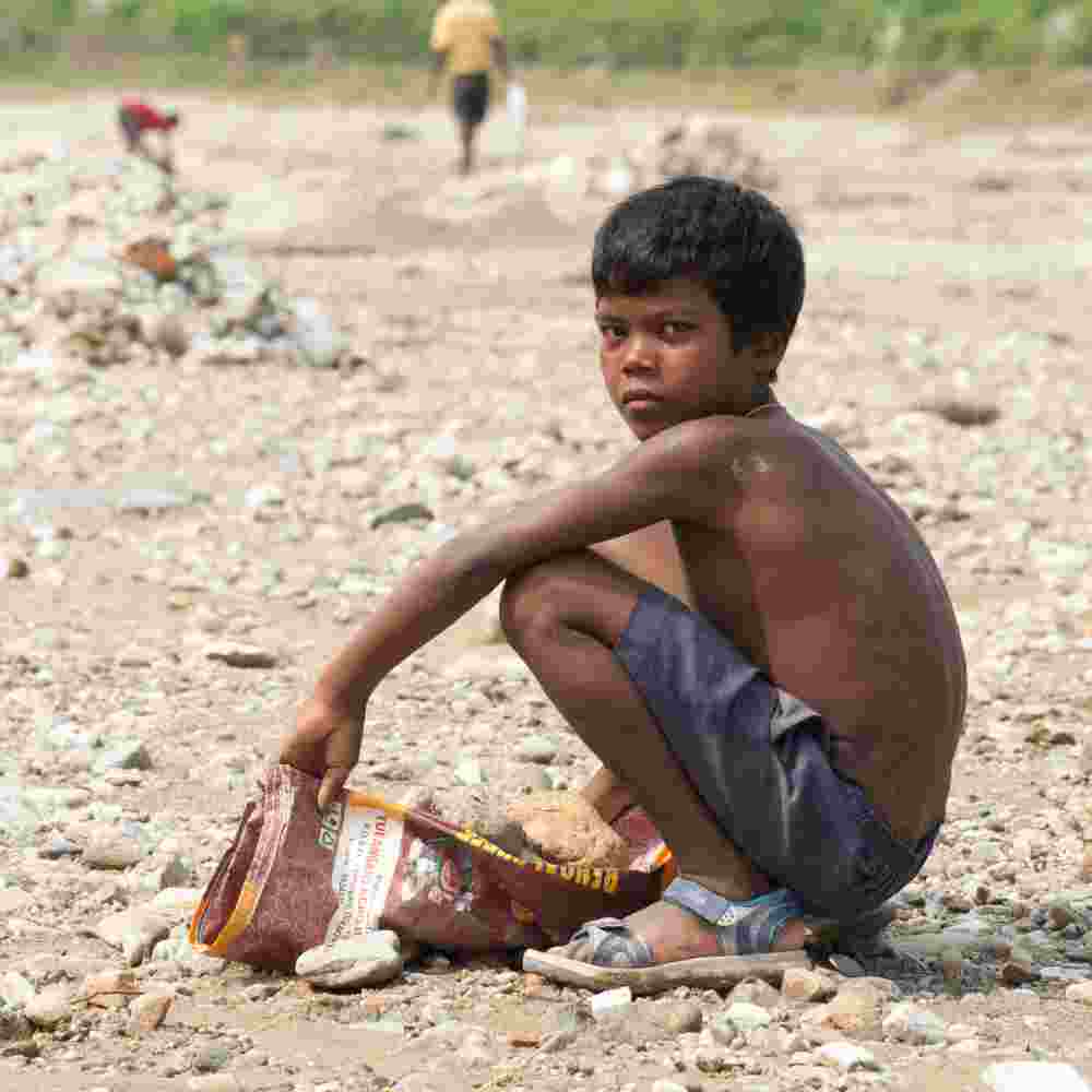 A young boy employed in labor instead of getting an education due to poverty
