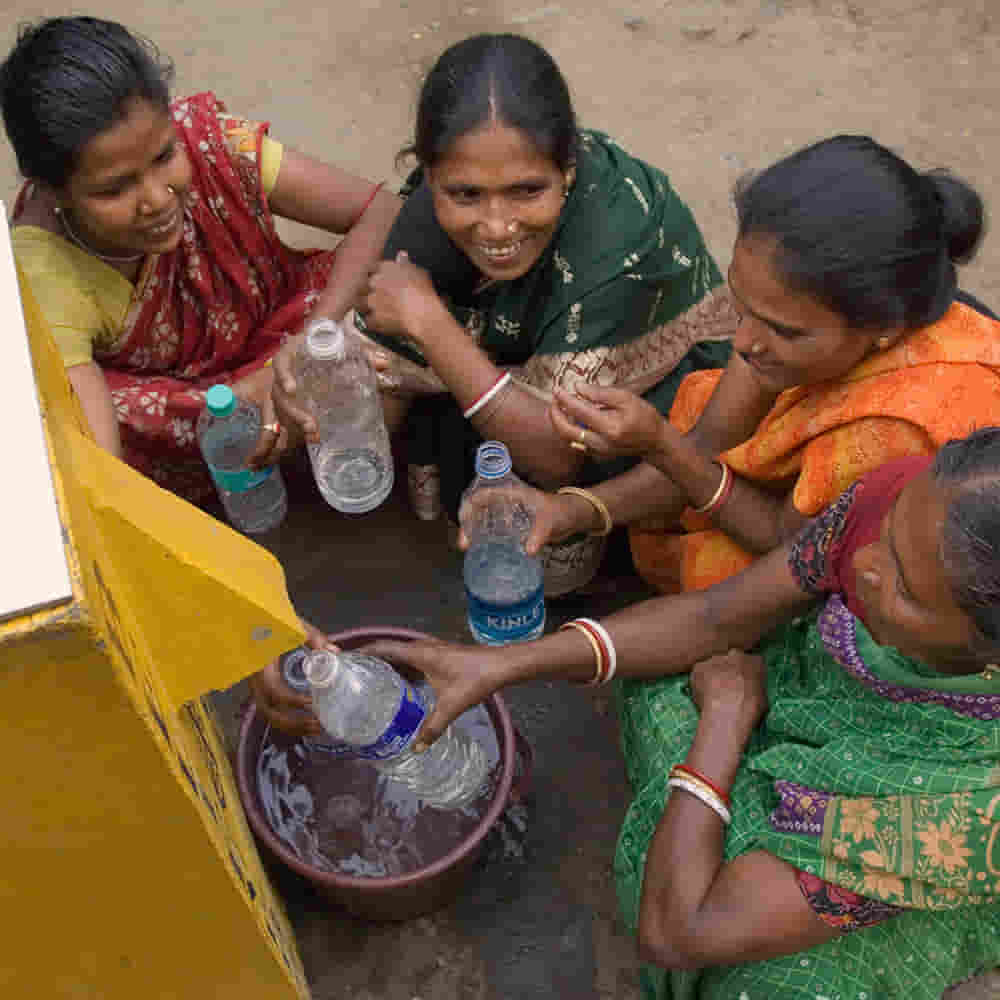 Group of women acquiring clean water from BioSand water filters