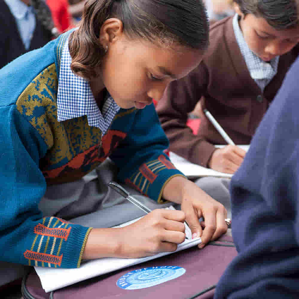 Girl studying in GFA World child sponsorship Bridge of Hope