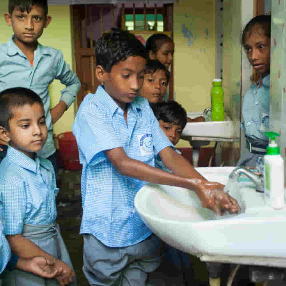 Children studying in GFA World child sponsorship program Bridge of Hope learn hand washing