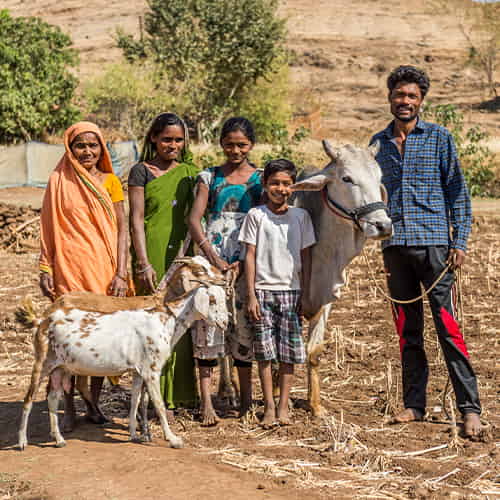 Taden and his family with income generating gifts of a cow and goats from GFA World gift distribution