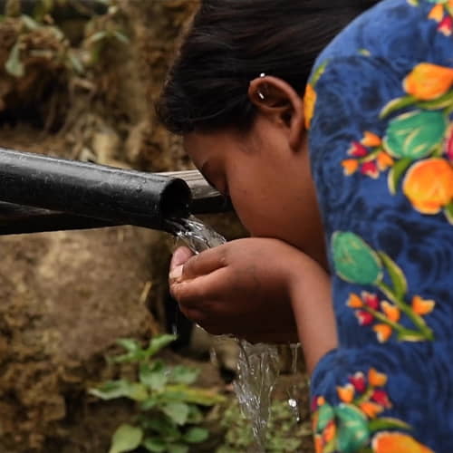 Girl drinking from unsafe water sources