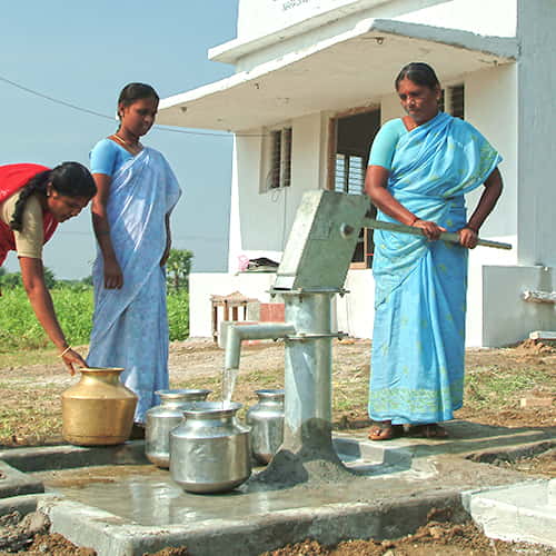 Women drawing clean water from a Jesus Well drilled by GFA World