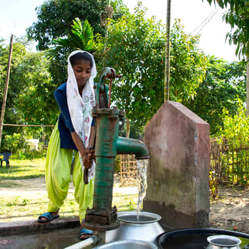 Woman draws clean water through GFA World Jesus Wells