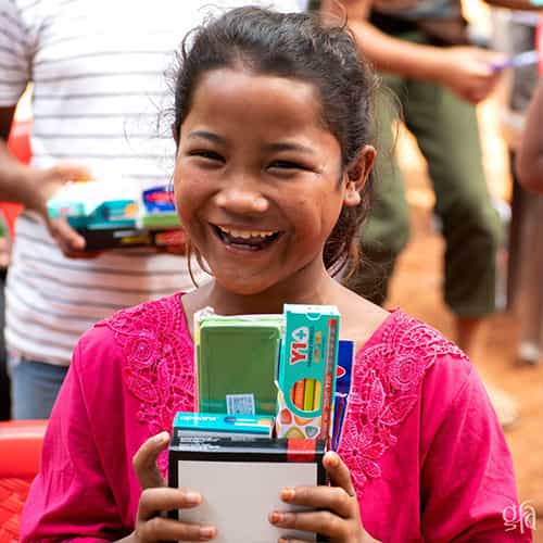 Young girl receives school supplies through GFA World child sponsorship program