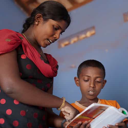 GFA World child sponsorship teacher instructing a child student