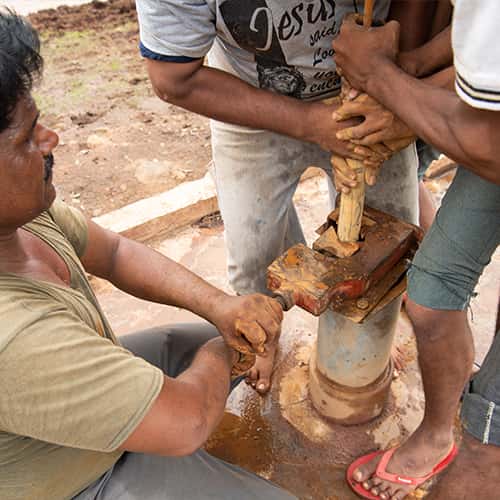 Local villagers perform maintenance on GFA World Jesus Wells