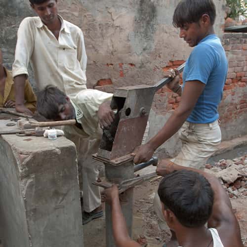 Local villagers perform maintenance on GFA World Jesus Wells
