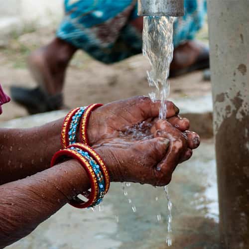 Leprosy patient washes hands with clean water through GFA World Jesus Wells