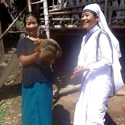 Woman receives income generating gift of a chicken through GFA World woman missionary
