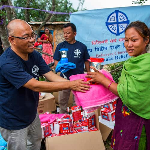 Victims of the earthquake in Nepal receive disaster relief supplies from GFA World compassion services national missionaries