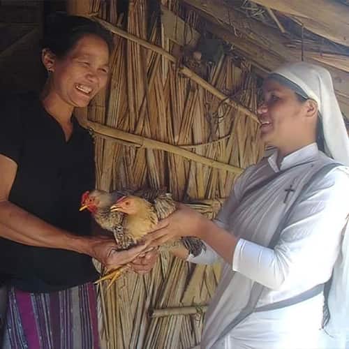 Neha, a widow, receives a pair of income generating chickens through a GFA World woman missionary
