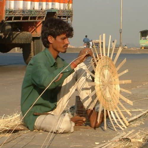A basket weaver in an impoverished community in South Asia