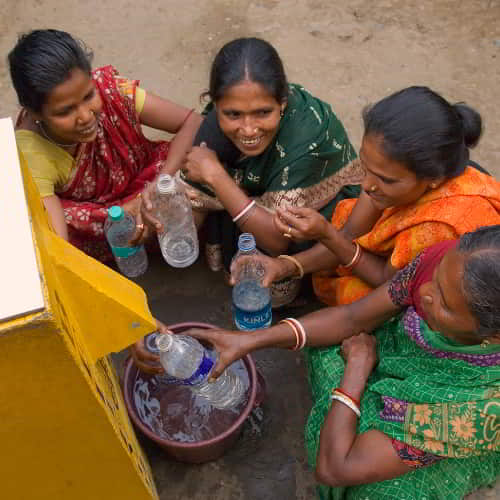 Women drawing clean water through GFA World BioSand water filter