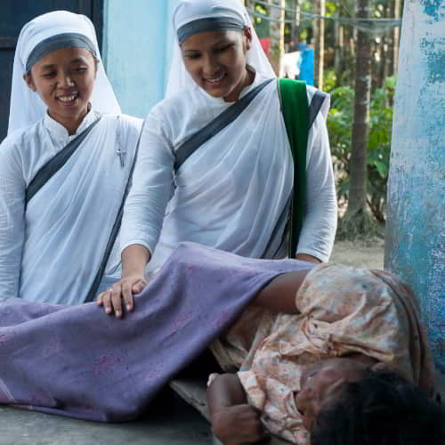 GFA World women missionaries praying for the sick