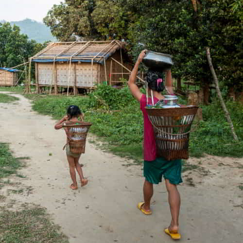 Mother and child walking long distances to collect water that is often from contaminated sources