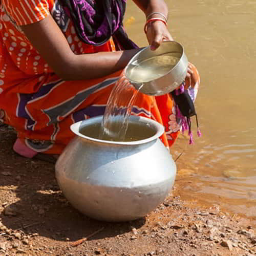 Woman in poverty dependent on unclean water sources