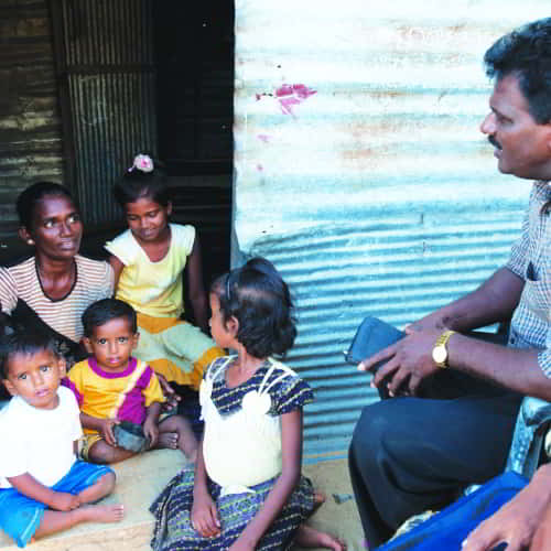 A woman with her children receiving support from GFA World