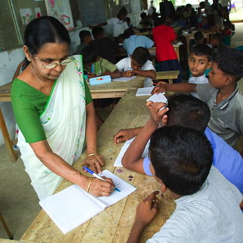 Teacher instructing students in GFA World Child Sponsorship Program in Sri Lanka