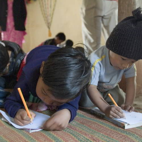 Children writing down notes in GFA World child sponsorship program