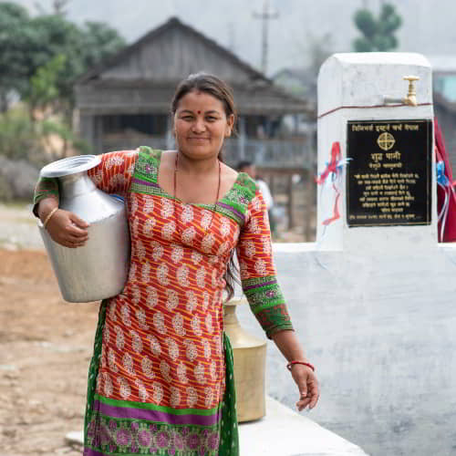 Women collected clean water through GFA World Jesus Wells