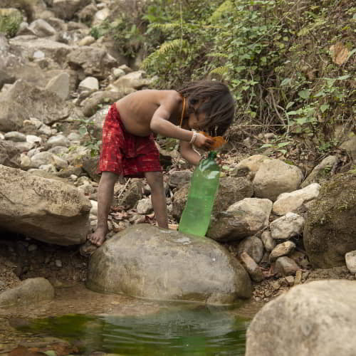 Child collects dirty water due to water scarcity
