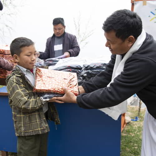Young boy receives school supplies from GFA World child sponsorship program