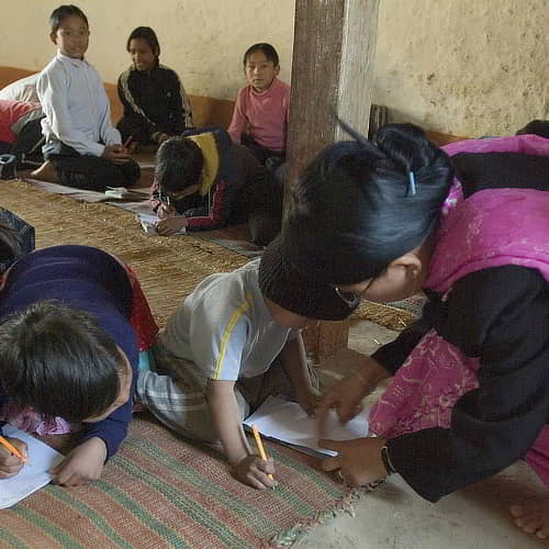 Teacher guides a student in GFA World child sponsorship an Underprivileged Kids in South Asia Charity