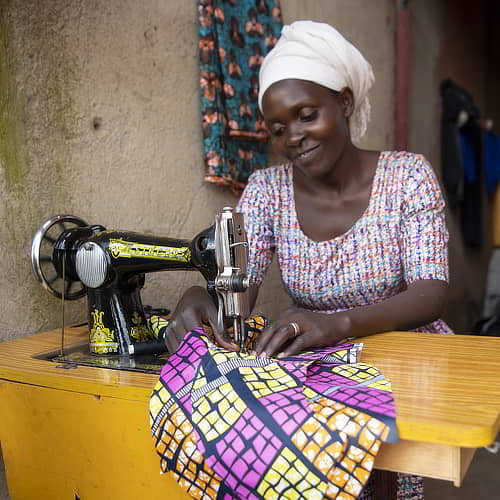 Woman received an income generating gift of a sewing machine through organizations that help widows and orphans like GFA World