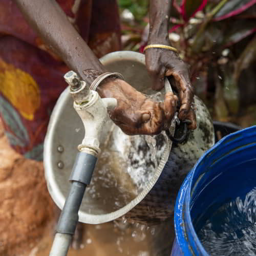 Women collecting clean water through GFA World Jesus Wells