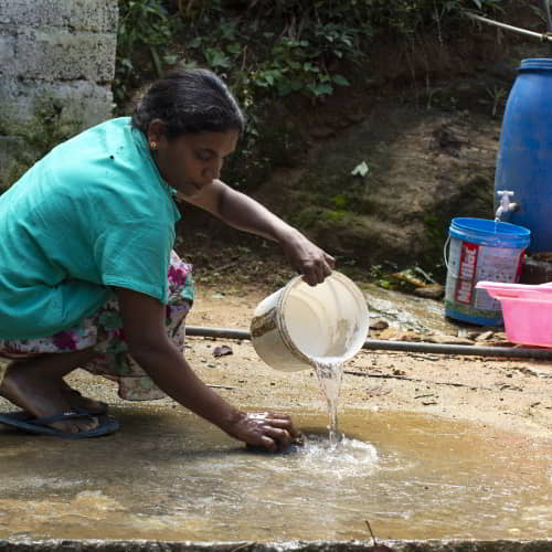 Woman washing with clean water from Jesus Wells