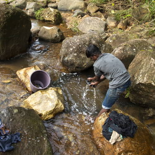 Man washing using an unclean water source