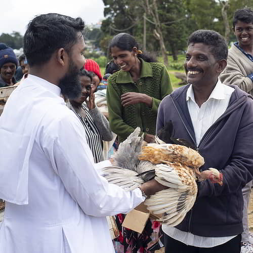 Man in poverty received an income generating animal of chickens through GFA World gift distribution