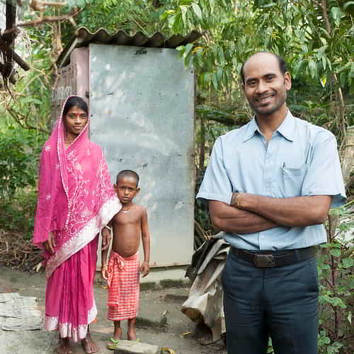 GFA World national missionary helps provide a family with an outdoor toilet