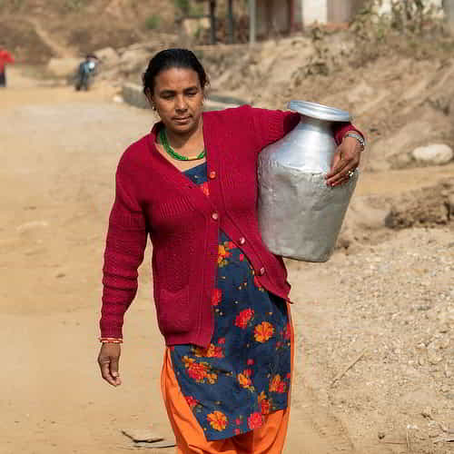 Woman carrying a jar of clean water collected from GFA World Jesus Wells