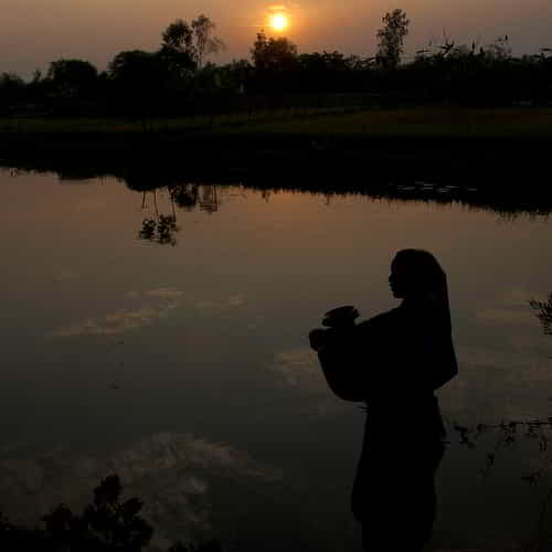 Woman standing by a river