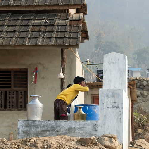 Young boy drinking clean water through GFA World Jesus Wells