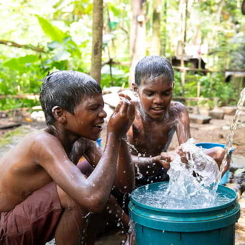 Young boys enjoying clean water through GFA World Jesus Wells