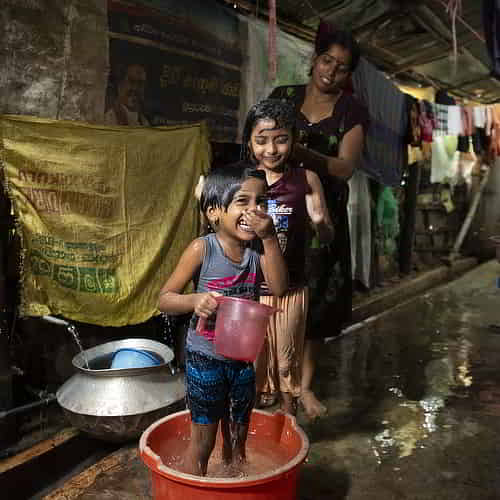 Family enjoys a clean water bath through GFA World Jesus Wells