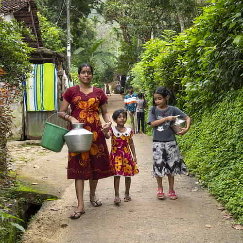 Mother and her children walking long distances to collect water