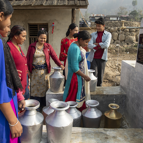 Village community collecting clean water through GFA World Jesus Wells