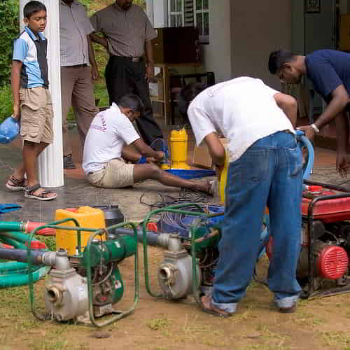 GFA World workers working on water pumps