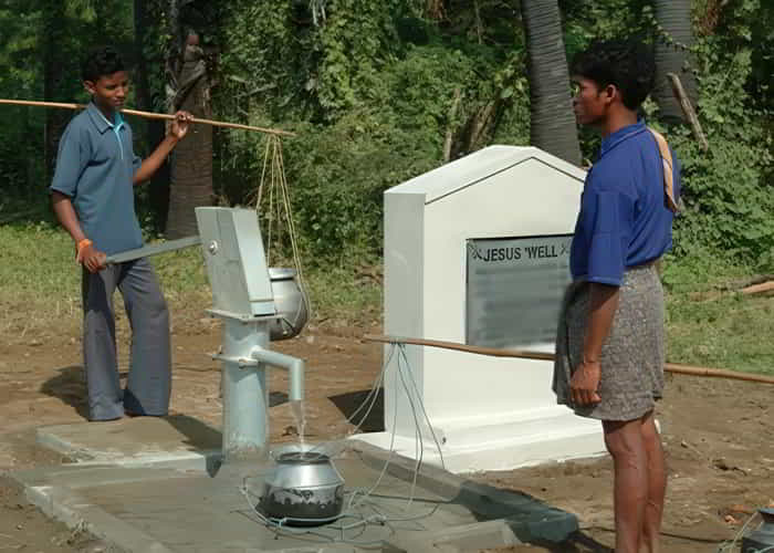 Young men drawing clean water through GFA World Jesus Wells