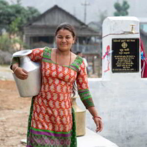 Nepalese woman carrying a jar of clean water drawn through GFA World Jesus Wells