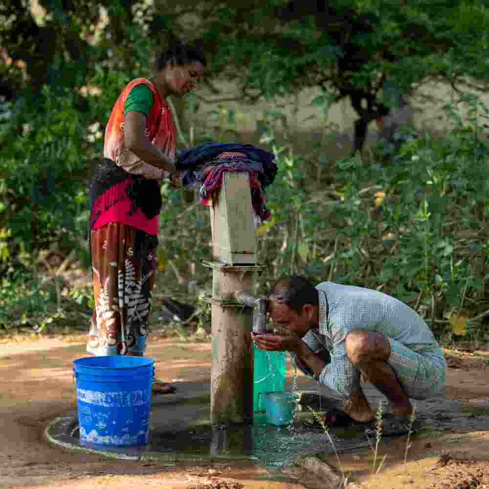 Husband and wife enjoys clean water through GFA World Jesus Wells after a day of hard labor