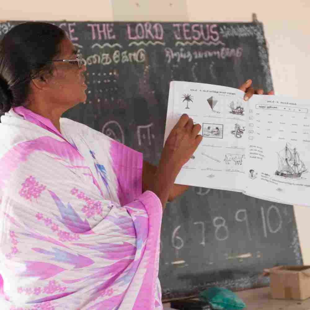 GFA World woman missionary teaching an adult literacy class
