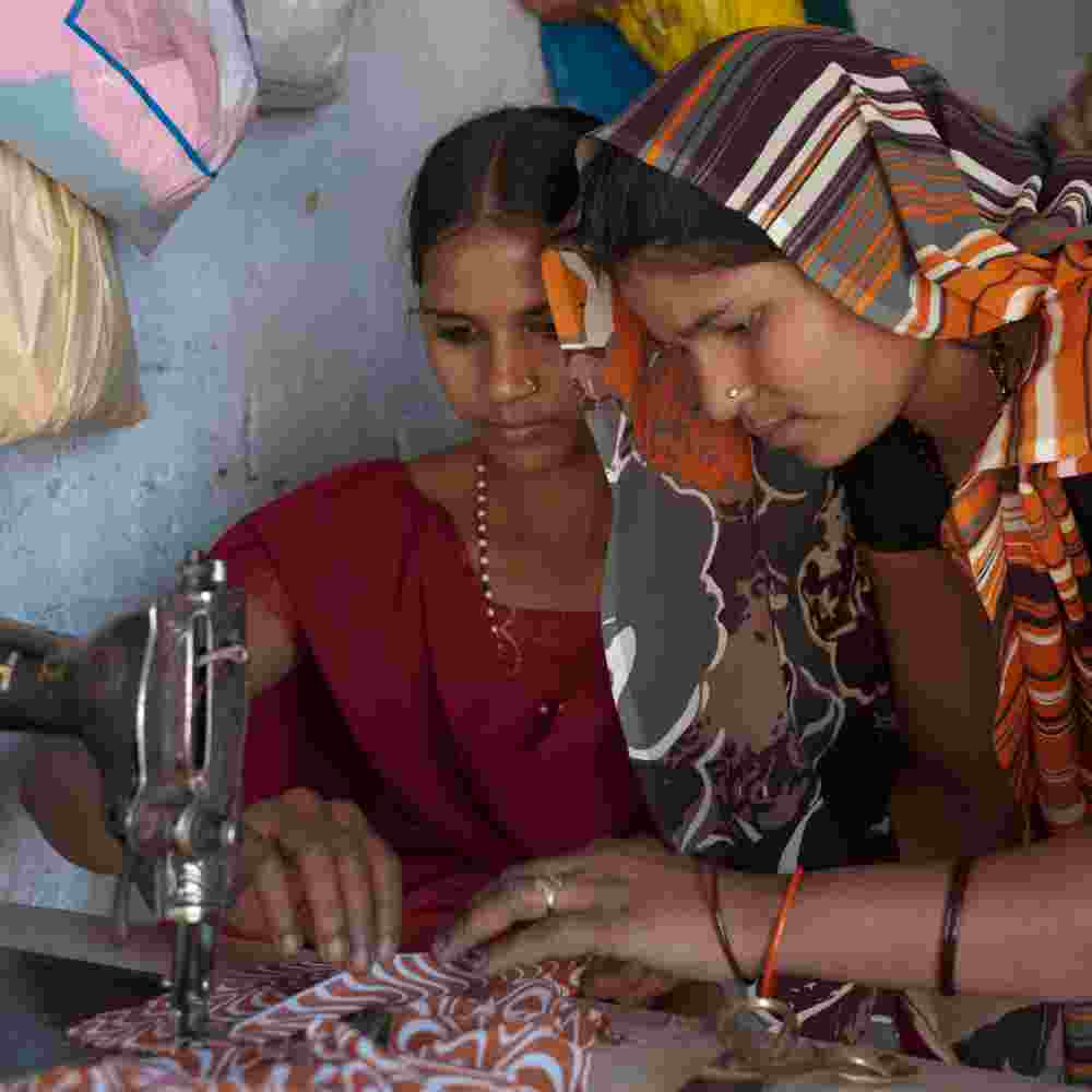 Woman learning how use a sewing machine through GFA World tailoring class