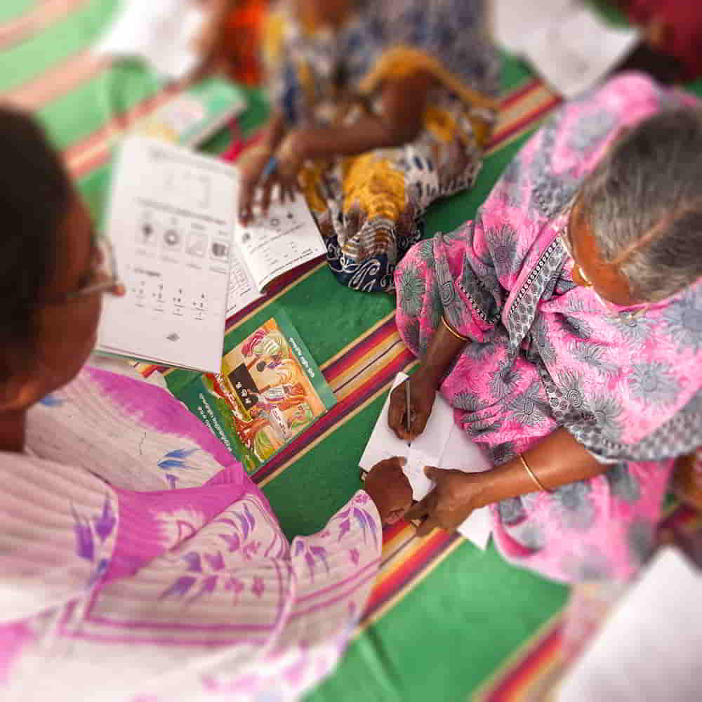 Woman missionary teaching literacy in GFA World adult literacy class